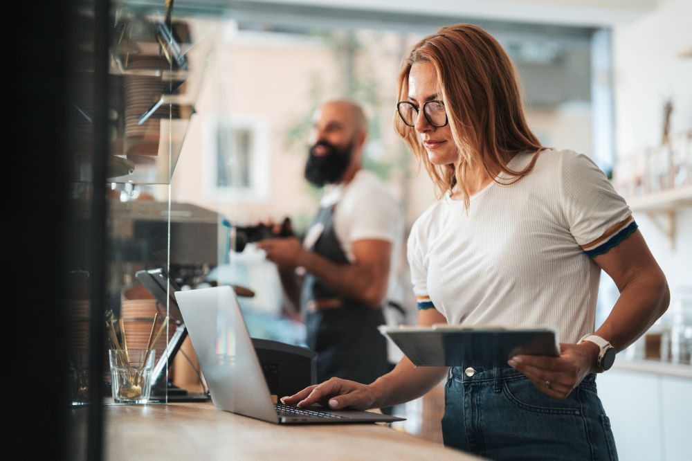 Multi-Unit Franchise Owner Managing Operations After Transition Franchise owner managing operations and reviewing data during a business transition