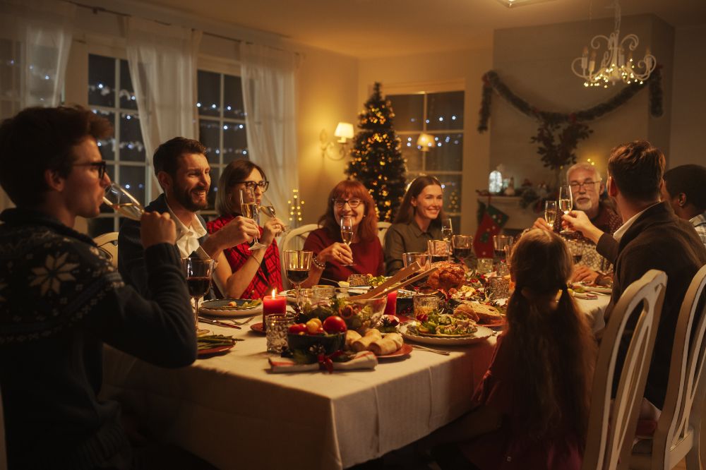 Family gathered around a holiday dinner table enjoying a festive meal, representing how clear communication supports family franchise holiday conflict prevention.