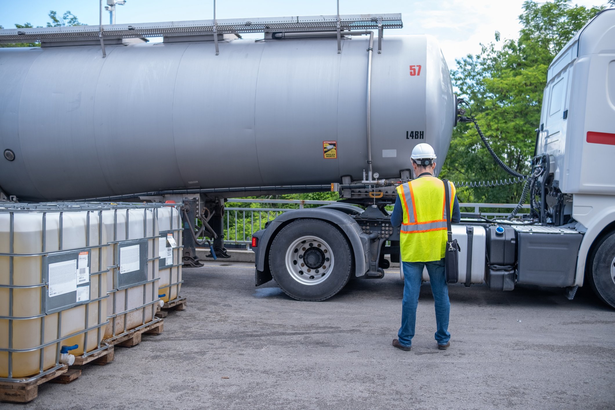 Fuel worker overseeing tanker operations, representing fuel business succession planning, owner dependence, and leadership continuity.