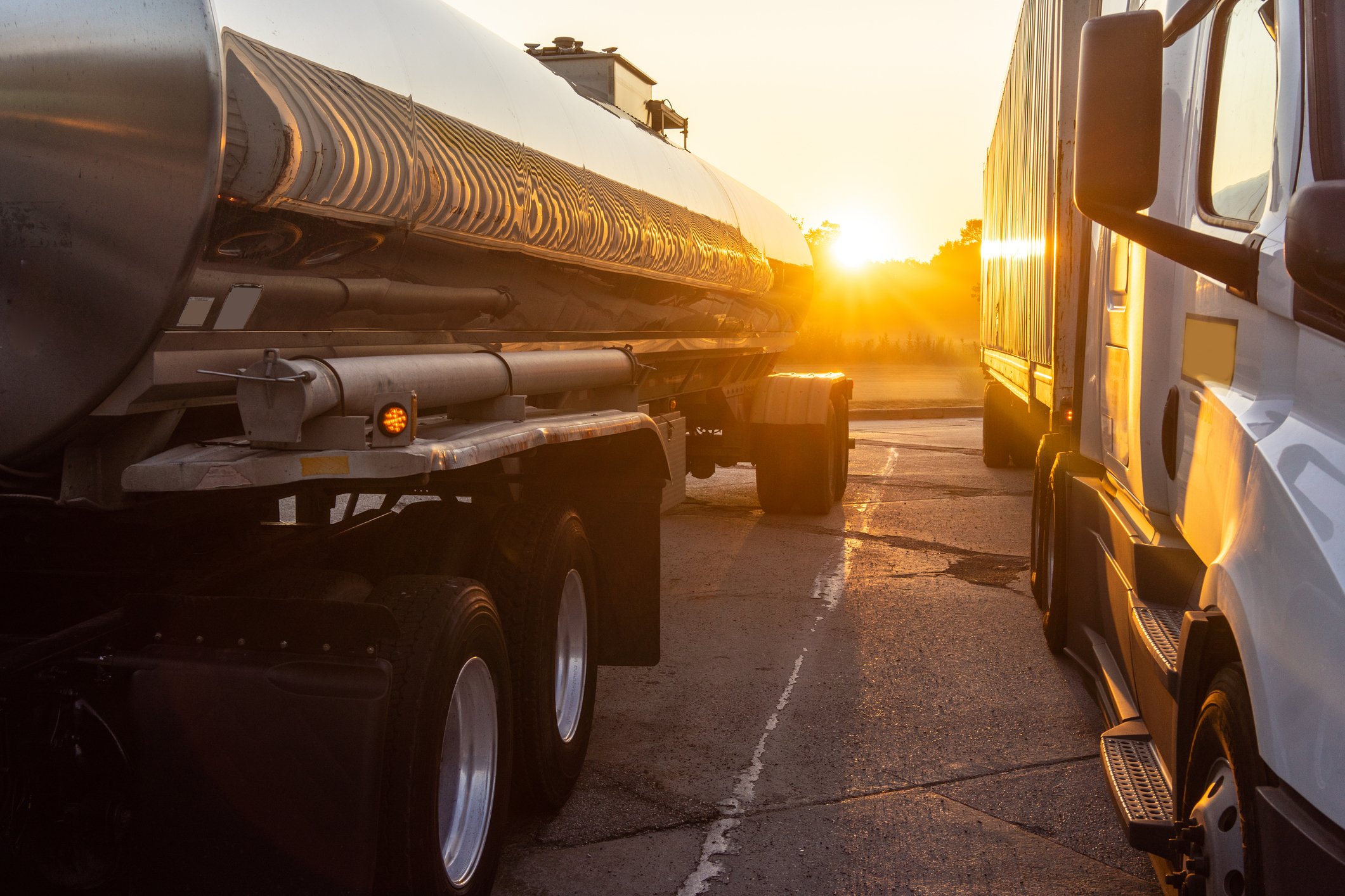 Fuel delivery trucks at sunrise representing succession planning for fuel and propane businesses, leadership continuity, and long-term business transition.