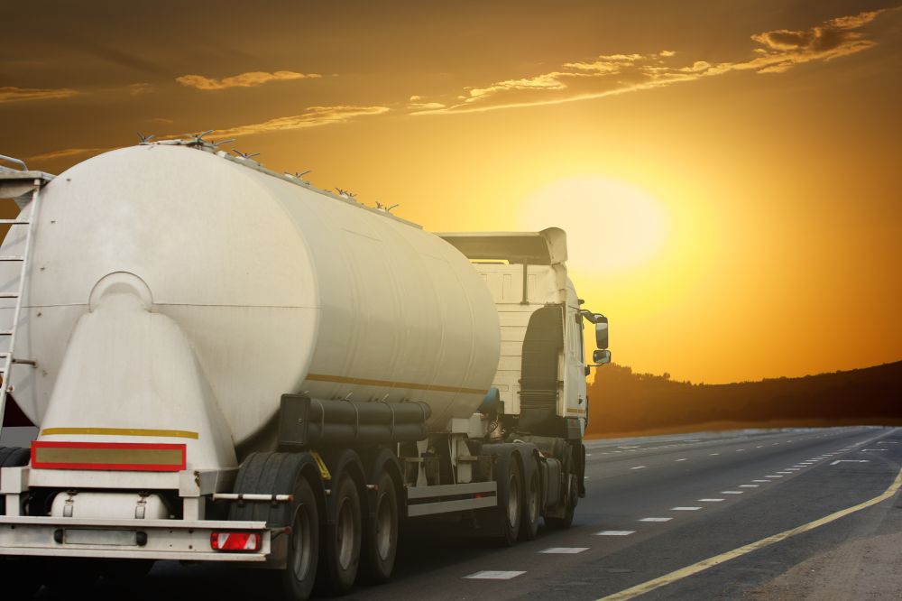Home Comfort Business Exit Strategy – Planning for Fuel, Propane, and Energy Delivery Companies Fuel delivery truck driving on a highway at sunset, symbolizing a home comfort business exit strategy and long-term succession planning for propane and heating oil companies.
