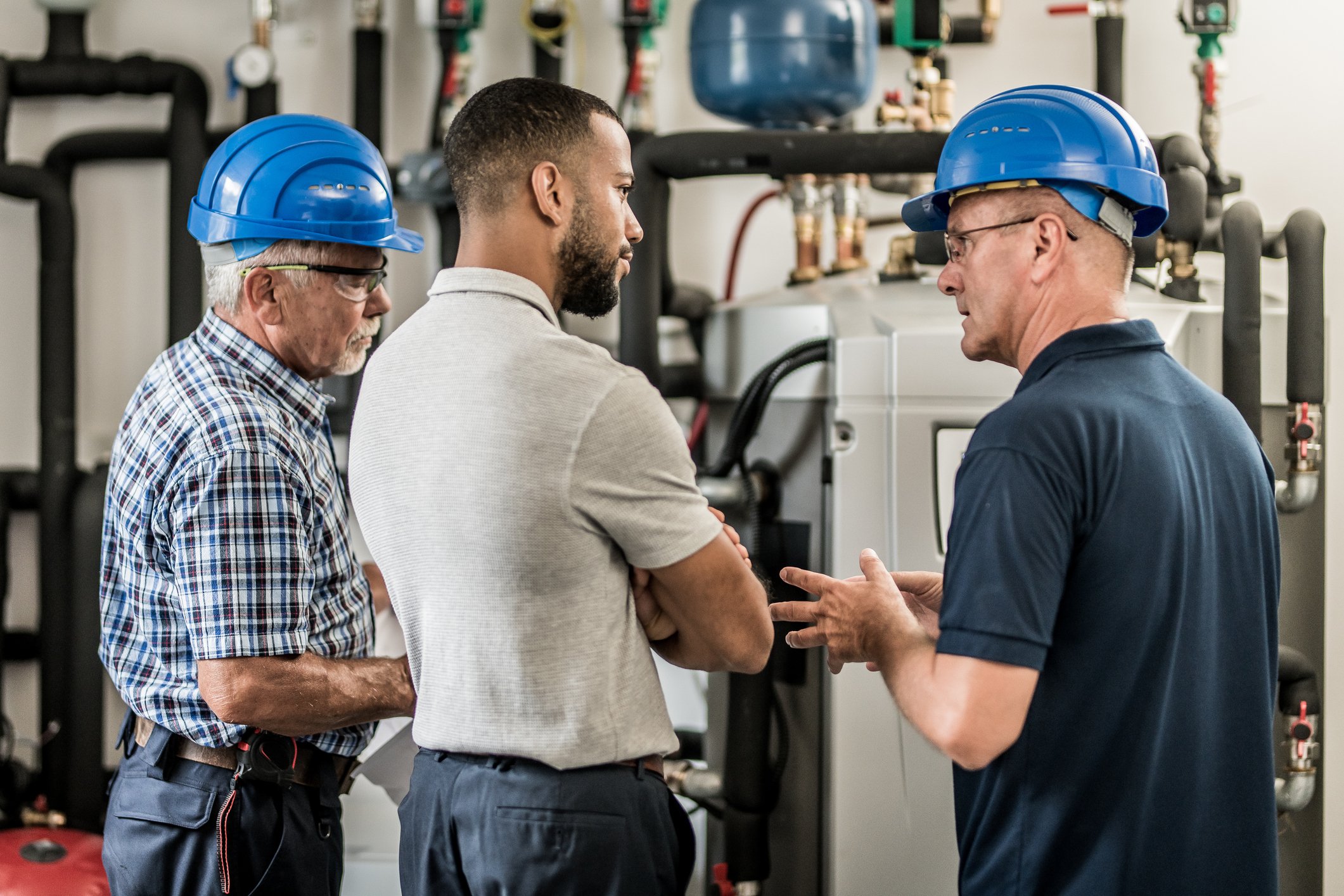 HVAC business leaders reviewing equipment and succession planning before retirement.